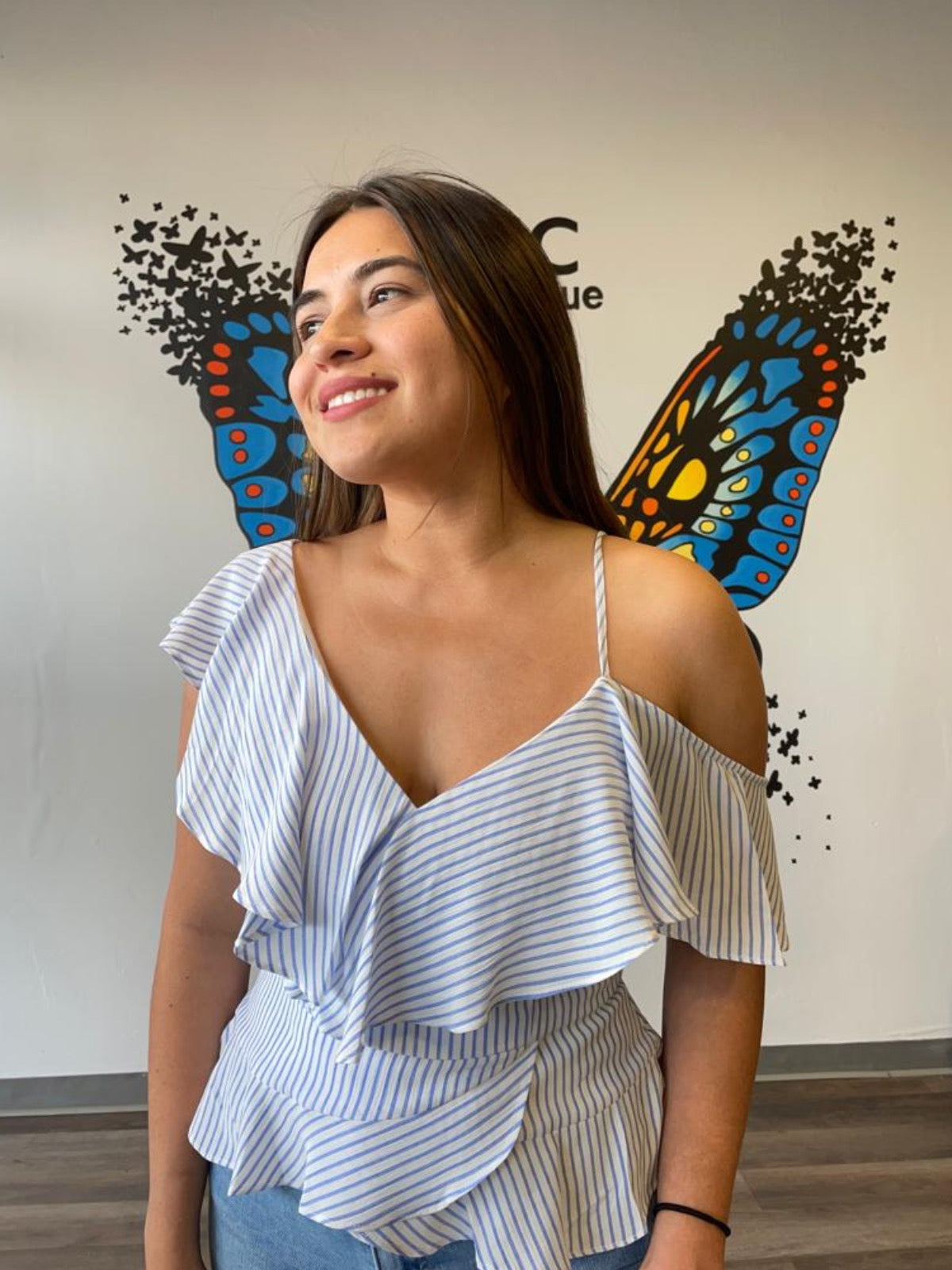 Spend a sunny day by the sea with this beautiful blouse! A blue and white striped print creates a bold and refreshing vibe in a fresh fabric, with a fitted bodice, asymmetrical ruffled sleeves and a flirty cut. Combine this blouse with our white wide leg pants or jeans. Add platforms or flats...either way you'll feel confident and beautiful.